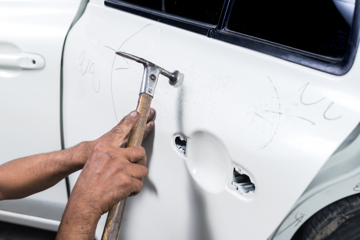 Car paint repair series : Worker repairs white car paint
